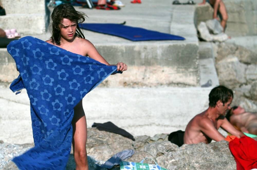 Nudist Rocky Family Angle - In naturism, nature serves as the bodys natural clothing