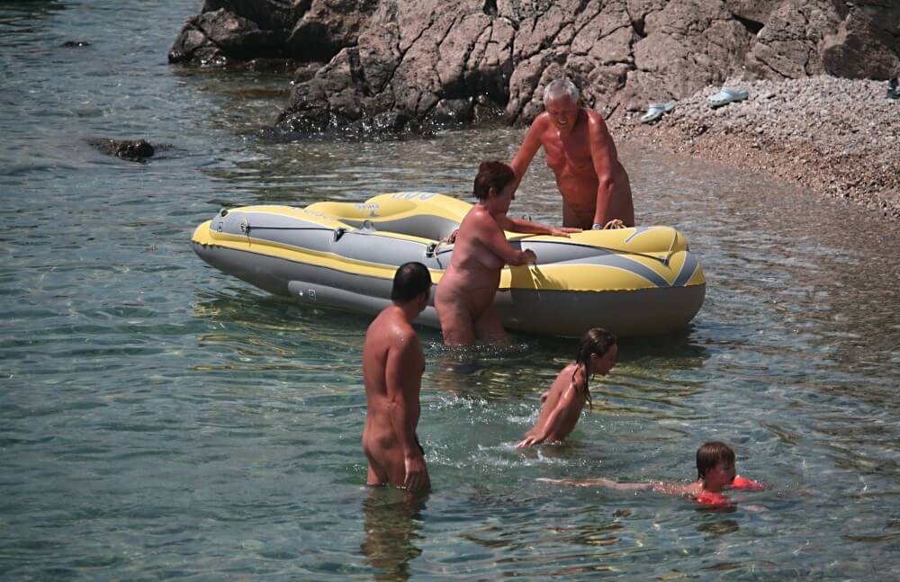 Lone Nudist in Yellow Boat photos - Naturists live freely and naturally